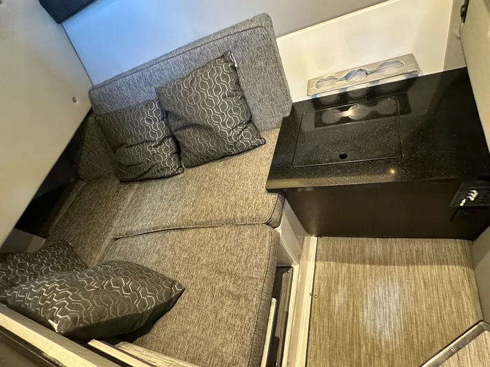  Yacht Photos Pics 2022 Cobalt R33 interior with gray seating and compact kitchenette.