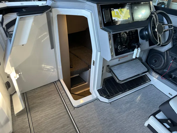  Yacht Photos Pics Interior of 2022 Cobalt R33 boat with modern dashboard and cabin entrance.