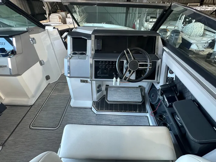  Yacht Photos Pics 2022 Cobalt R33 boat interior with modern steering and dashboard controls.