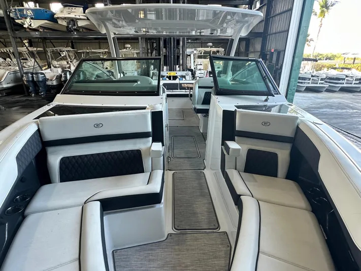  Yacht Photos Pics 2022 Cobalt R33 boat interior with luxurious seating in a marina setting.