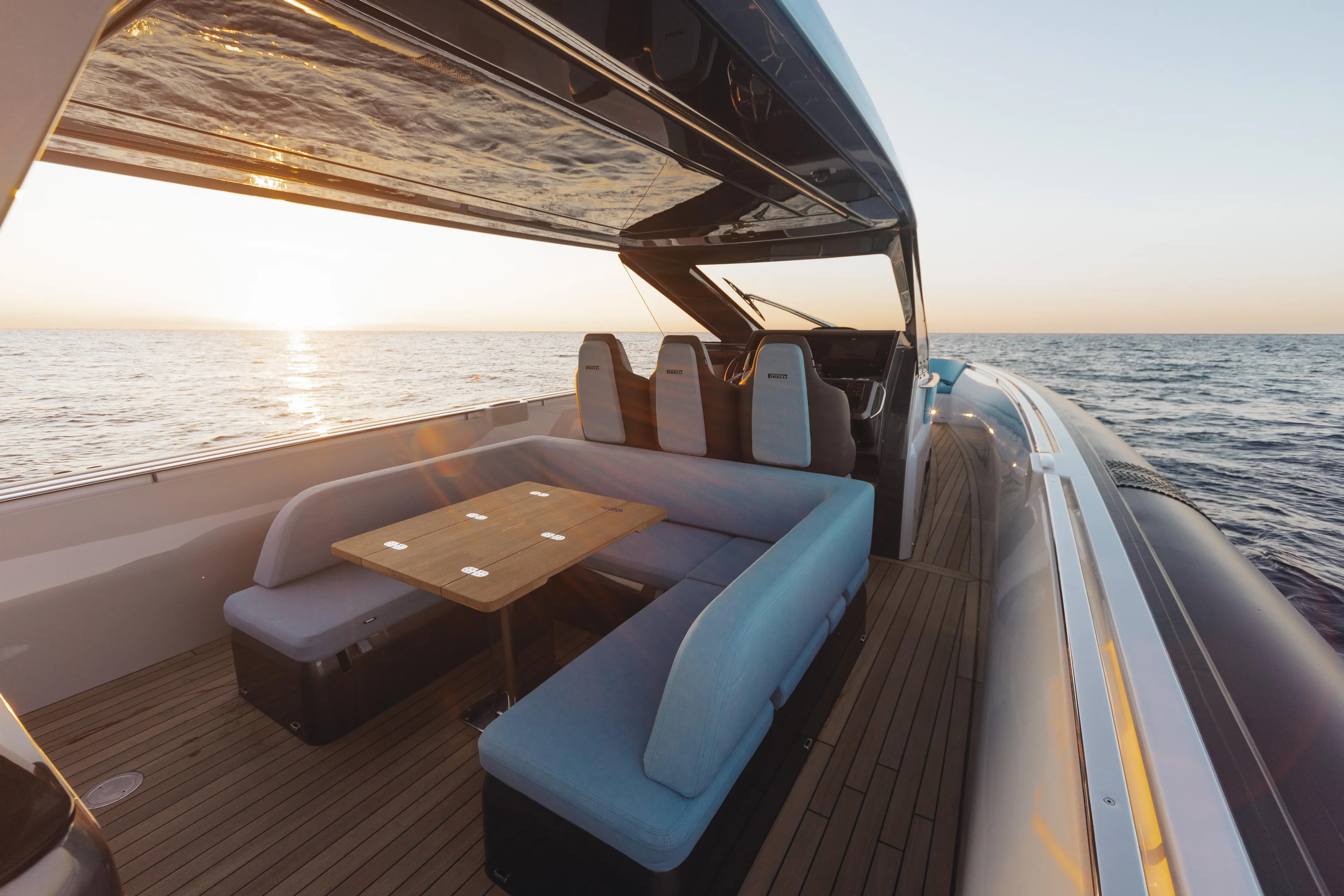  Yacht Photos Pics Luxurious 2026 Pirelli 47 yacht interior with ocean view at sunset.