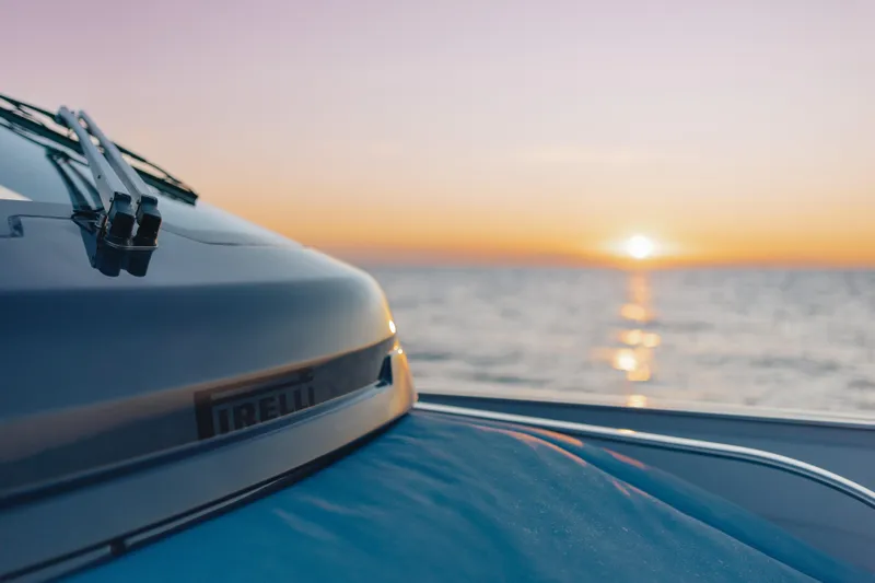  Yacht Photos Pics 2026 Pirelli 47 boat at sunset on the ocean.