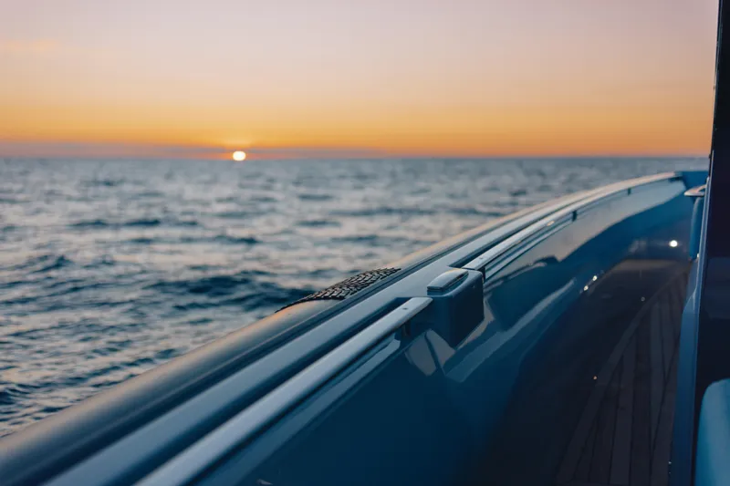  Yacht Photos Pics Luxury Pirelli 47 yacht cruising at sunset, 2026 model, on open sea.