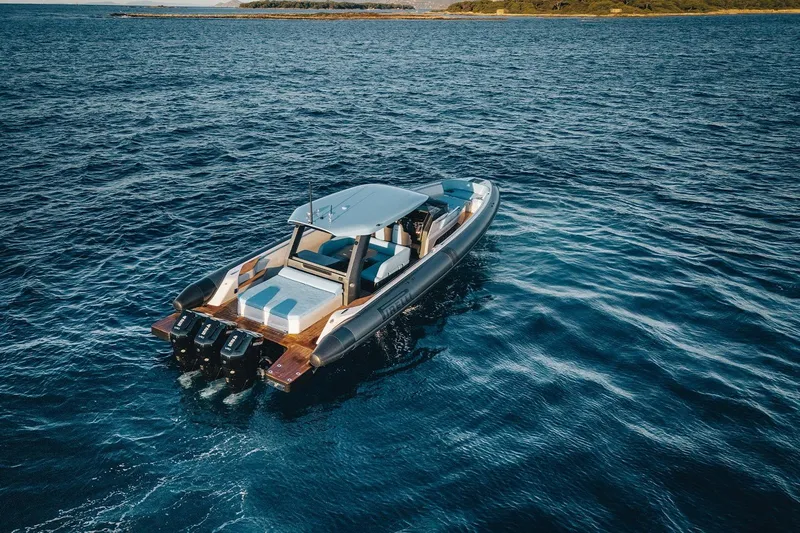  Yacht Photos Pics 2026 Pirelli 47 boat cruising on open blue sea, showcasing sleek design and powerful engines.