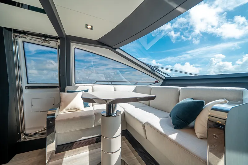 April Fools Yacht Photos Pics Luxurious interior of 2018 Azimut 80 Flybridge yacht with plush seating and ocean view.