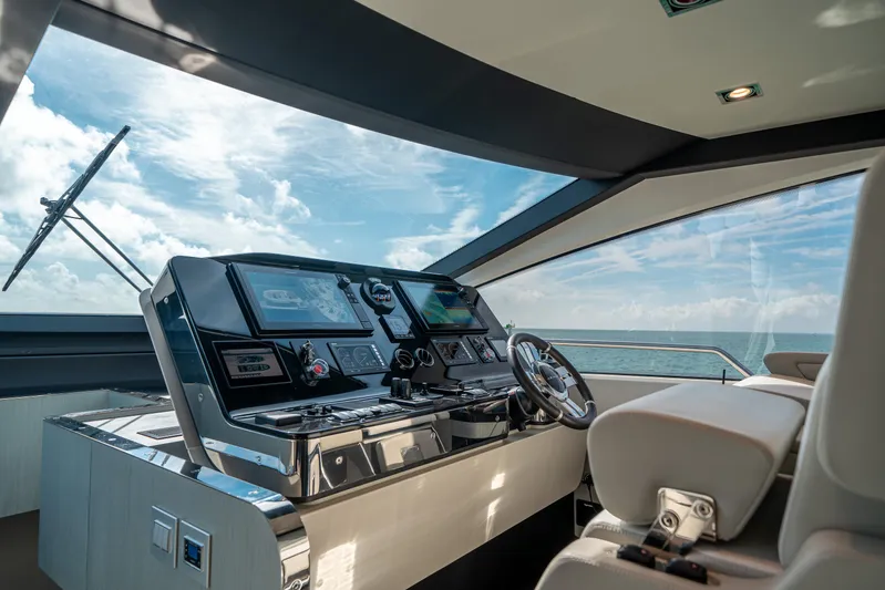 April Fools Yacht Photos Pics Cockpit of 2018 Azimut 80 Flybridge yacht with modern navigation equipment and ocean view.