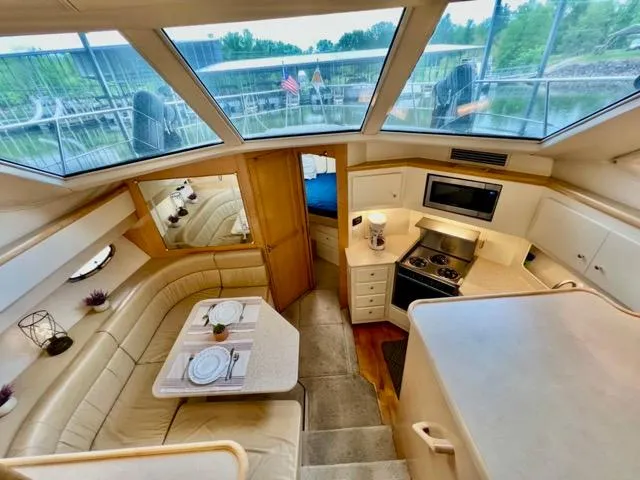 San Souci Yacht Photos Pics Interior of 1998 Carver 405 Motor Yacht with dining area and kitchen.