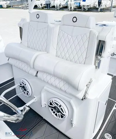  Yacht Photos Pics 2023 Fountain 34 TE boat with white cushioned seating and built-in speakers.