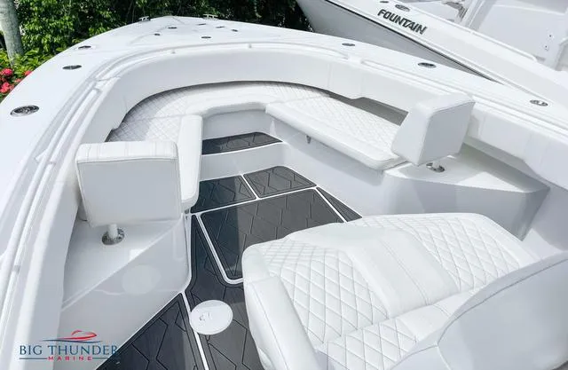  Yacht Photos Pics 2023 Fountain 34 TE boat interior with white quilted seating and Big Thunder Marine logo.