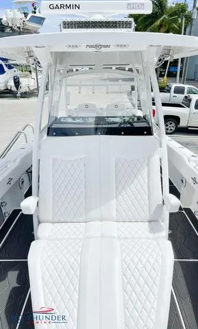  Yacht Photos Pics 2023 Fountain 34 TE boat with white diamond-stitched seating and Garmin electronics.