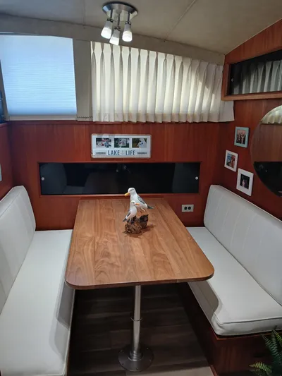  Yacht Photos Pics Interior of 1986 Bertram 46 Flybridge Motor Yacht with cozy dining area and decor.