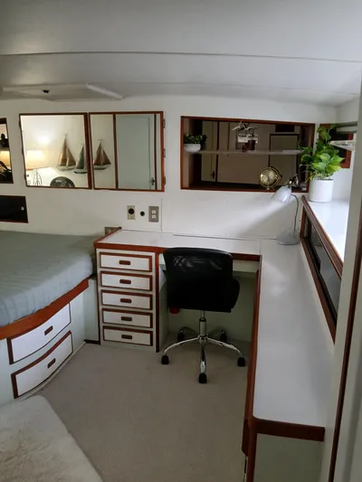  Yacht Photos Pics 1986 Bertram 46 Flybridge Motor Yacht interior with desk, chair, and decor elements.