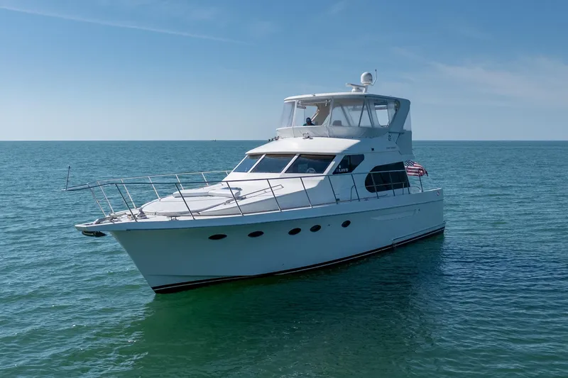 Port-folio Yacht Photos Pics 2007 Ocean Alexander 52 Sedan yacht cruising on open sea under clear blue sky.
