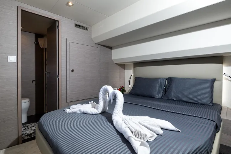  Yacht Photos Pics Luxurious bedroom in 2022 Fountaine Pajot MY6 yacht with elegant decor and swan towel art.