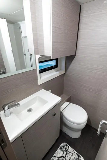  Yacht Photos Pics Modern bathroom in 2022 Fountaine Pajot MY6 yacht with sleek fixtures and ocean view.