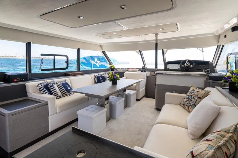  Yacht Photos Pics Luxurious interior of 2022 Fountaine Pajot MY6 yacht with elegant seating and ocean view.