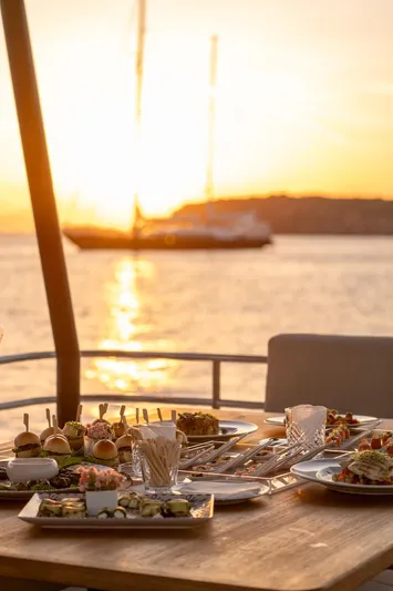  Yacht Photos Pics Sunset dining on 2022 Fountaine Pajot MY6 yacht with gourmet dishes.