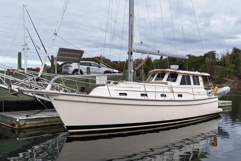  Yacht Photos Pics 2008 Island Packet SP Cruiser docked at a marina, surrounded by calm water.