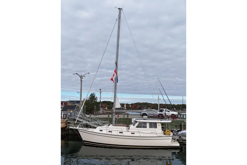  Yacht Photos Pics 2008 Island Packet SP Cruiser sailboat docked at a marina under cloudy skies.