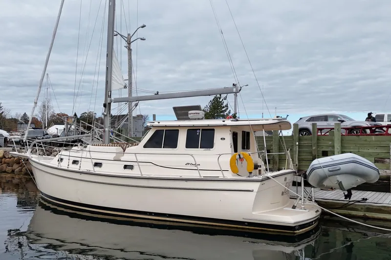  Yacht Photos Pics 2008 Island Packet SP Cruiser docked at marina with inflatable dinghy attached.