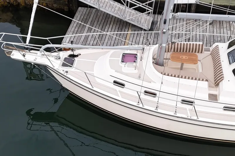  Yacht Photos Pics 2008 Island Packet SP Cruiser docked, featuring a spacious deck and seating area.