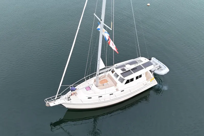  Yacht Photos Pics 2008 Island Packet SP Cruiser sailboat with solar panels on calm water.