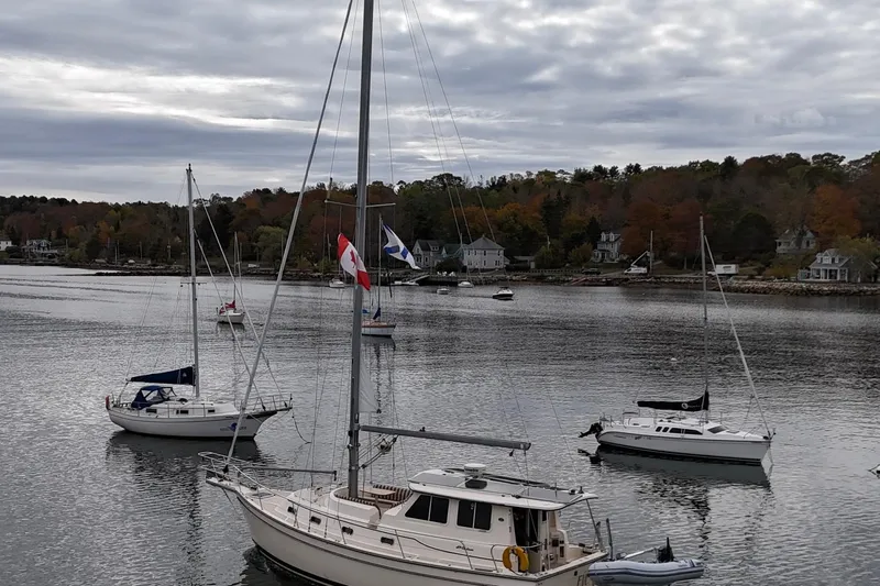  Yacht Photos Pics Sailboats anchored in a serene harbor, featuring a 2008 Island Packet SP Cruiser.