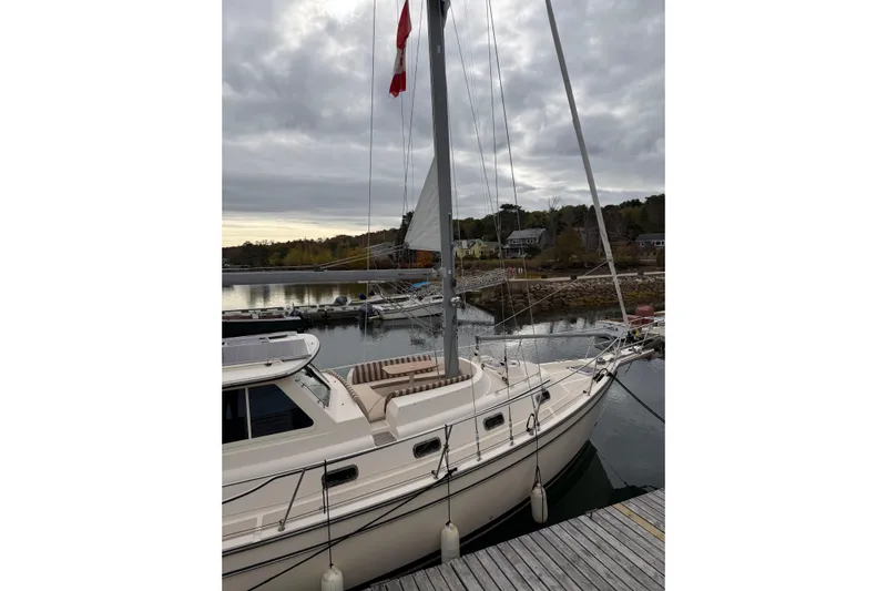  Yacht Photos Pics 2008 Island Packet SP Cruiser docked at a serene marina under cloudy skies.