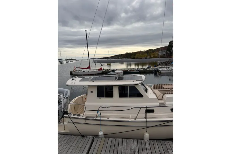  Yacht Photos Pics 2008 Island Packet SP Cruiser docked at a marina under cloudy skies.