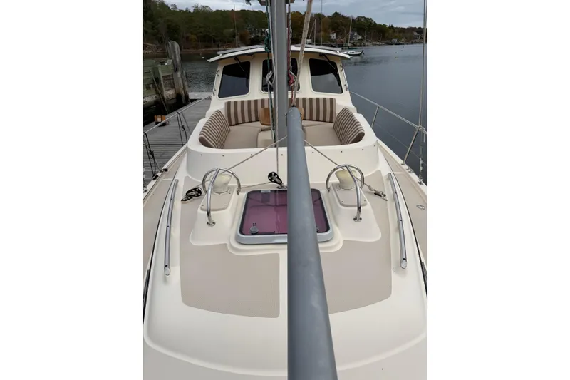  Yacht Photos Pics 2008 Island Packet SP Cruiser sailboat deck with seating and hatch, docked by the water.