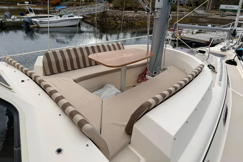  Yacht Photos Pics 2008 Island Packet SP Cruiser with striped seating and table, docked at marina.