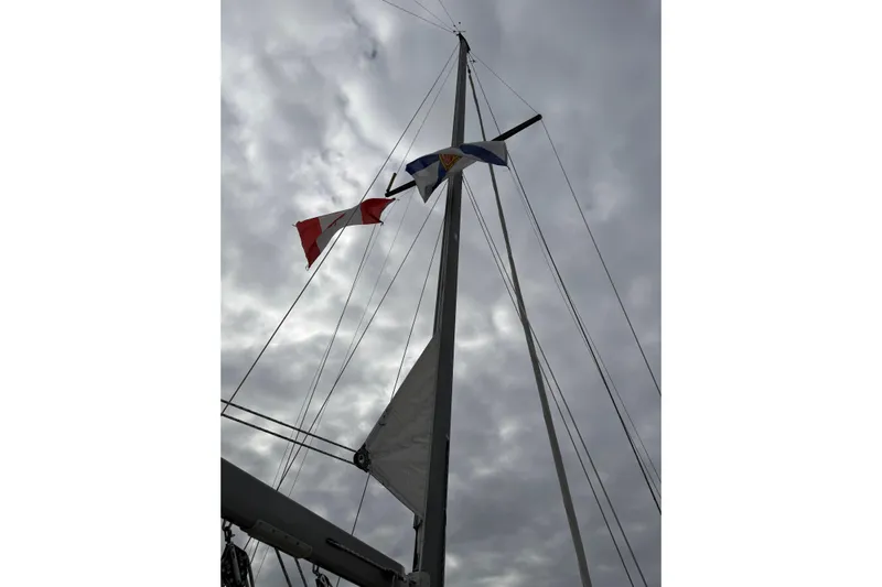  Yacht Photos Pics Mast of 2008 Island Packet SP Cruiser with flags against cloudy sky.