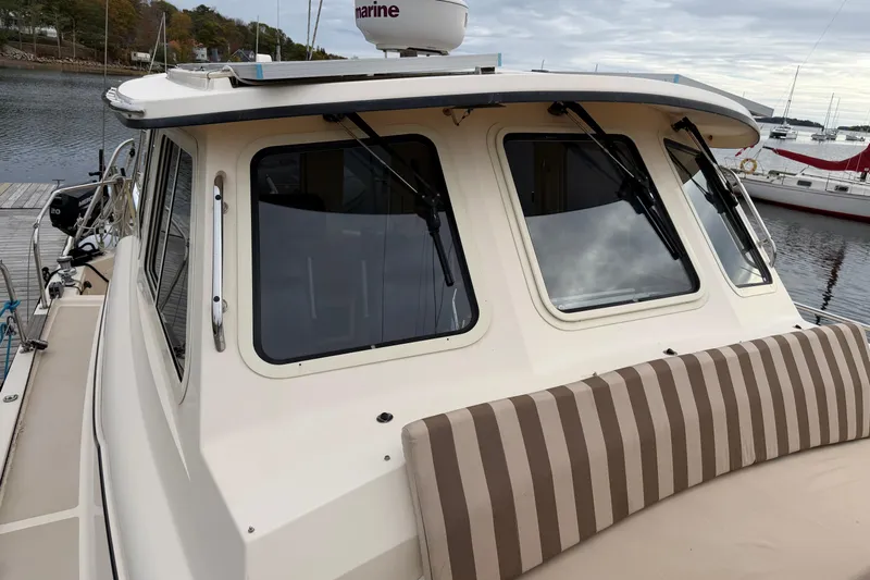  Yacht Photos Pics 2008 Island Packet SP Cruiser docked, featuring striped seating and large windows.