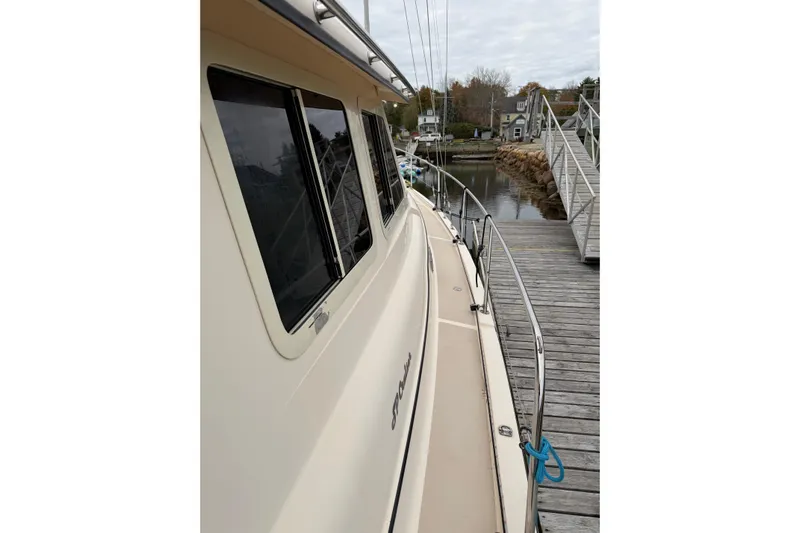  Yacht Photos Pics 2008 Island Packet SP Cruiser docked at a marina, side view with railing and windows.