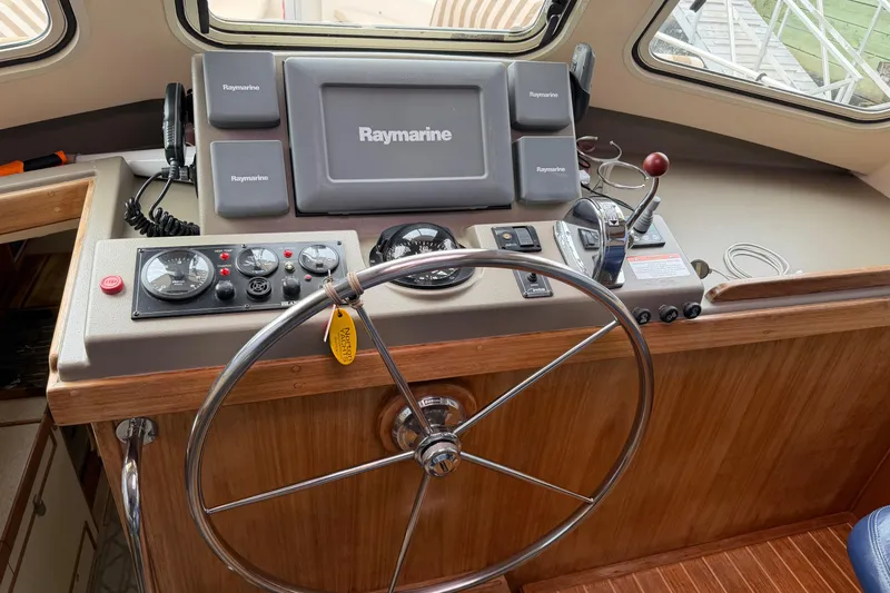  Yacht Photos Pics 2008 Island Packet SP Cruiser helm with Raymarine navigation system and steering wheel.