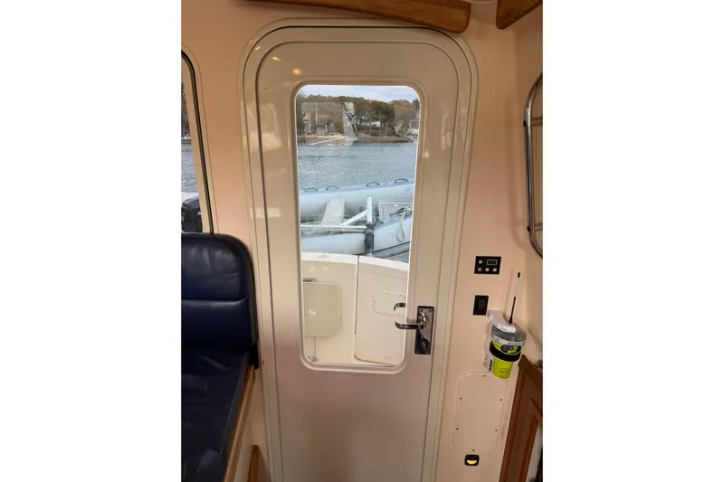  Yacht Photos Pics Interior view of 2008 Island Packet SP Cruiser door with window, overlooking water.