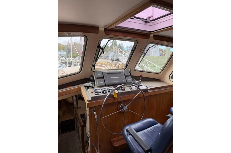  Yacht Photos Pics 2008 Island Packet SP Cruiser helm with navigation equipment and blue captain's chair.