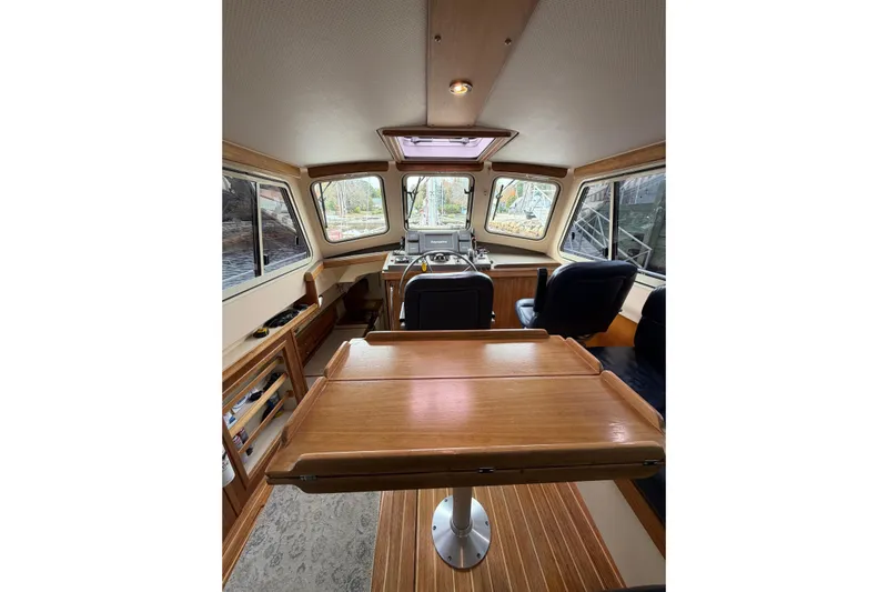  Yacht Photos Pics 2008 Island Packet SP Cruiser interior with wooden table and helm station.