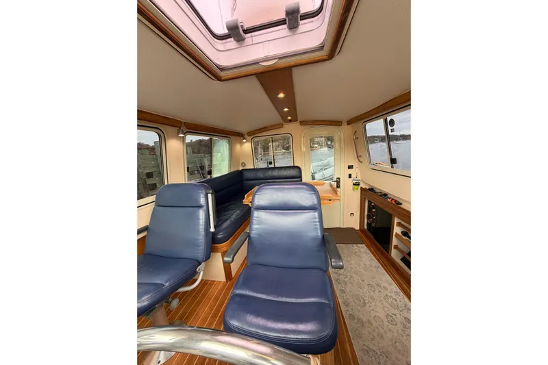  Yacht Photos Pics Interior of 2008 Island Packet SP Cruiser with blue seating and panoramic windows.