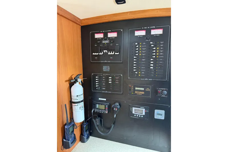  Yacht Photos Pics Electrical control panel of 2008 Island Packet SP Cruiser with fire extinguisher and communication devices.