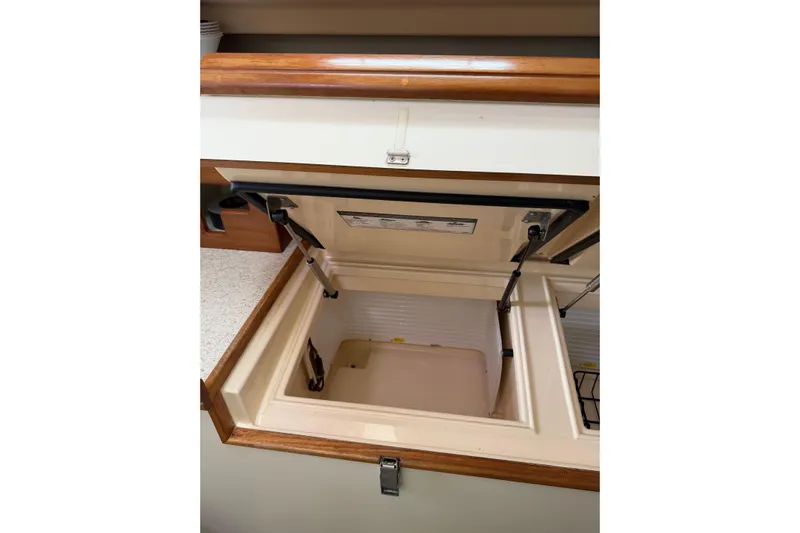  Yacht Photos Pics Open storage compartment in 2008 Island Packet SP Cruiser yacht kitchen.