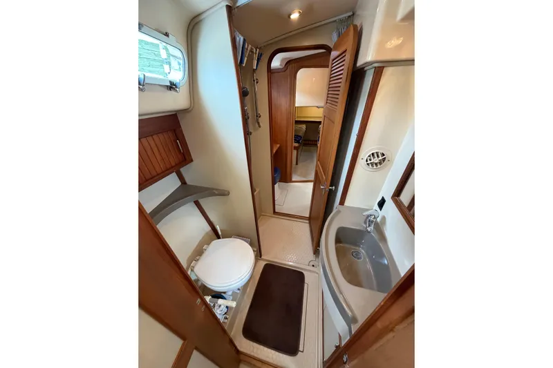  Yacht Photos Pics 2008 Island Packet SP Cruiser bathroom with toilet, sink, and wooden accents.