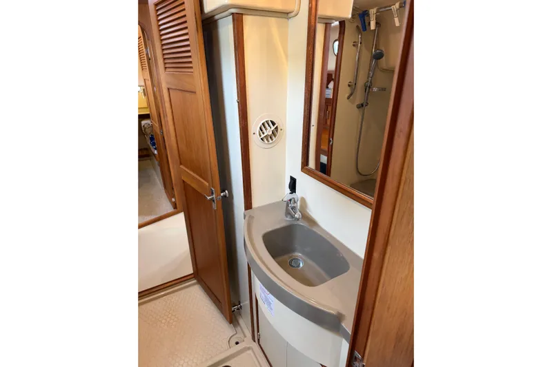  Yacht Photos Pics 2008 Island Packet SP Cruiser bathroom with sink, mirror, and shower.