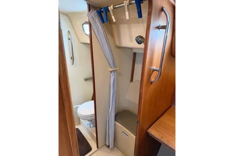  Yacht Photos Pics 2008 Island Packet SP Cruiser bathroom with shower, toilet, and wooden accents.
