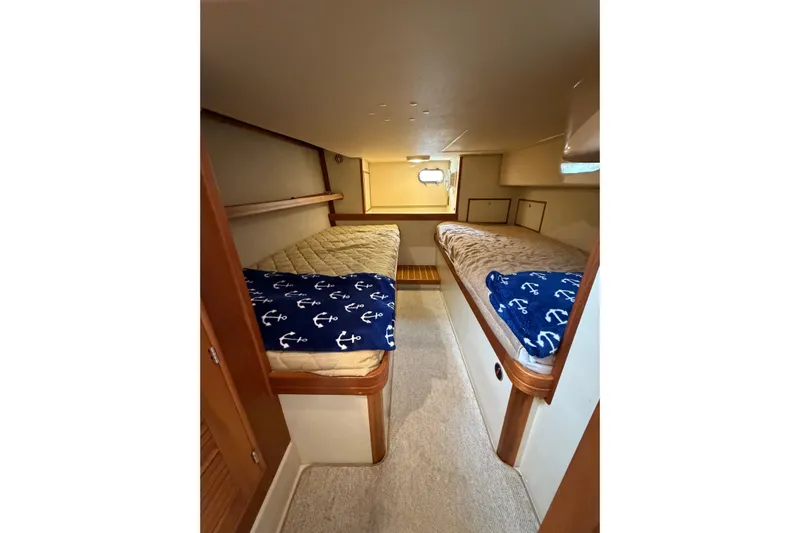  Yacht Photos Pics 2008 Island Packet SP Cruiser cabin with twin beds and nautical-themed decor.