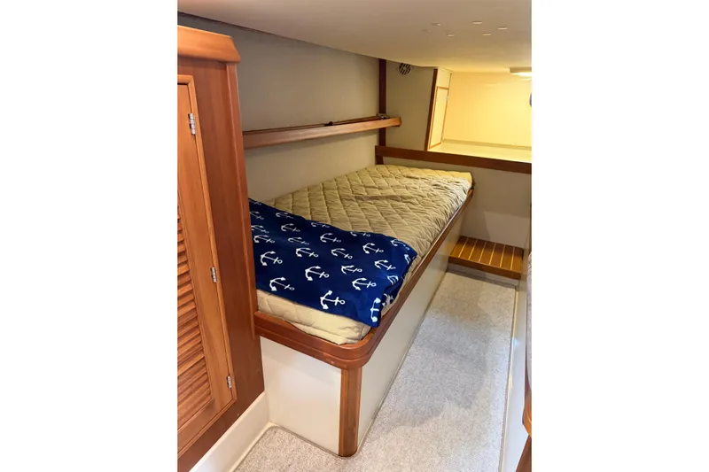  Yacht Photos Pics 2008 Island Packet SP Cruiser cabin with cozy bed and nautical-themed blanket.