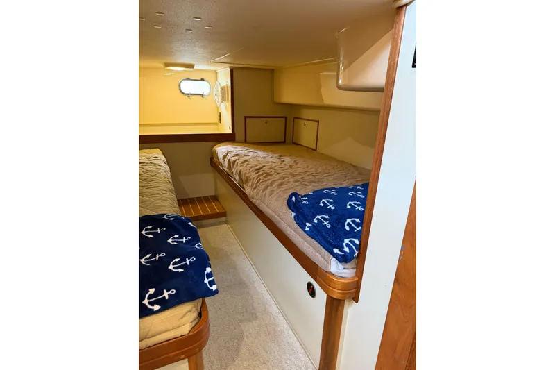  Yacht Photos Pics 2008 Island Packet SP Cruiser cabin with cozy beds and nautical-themed decor.