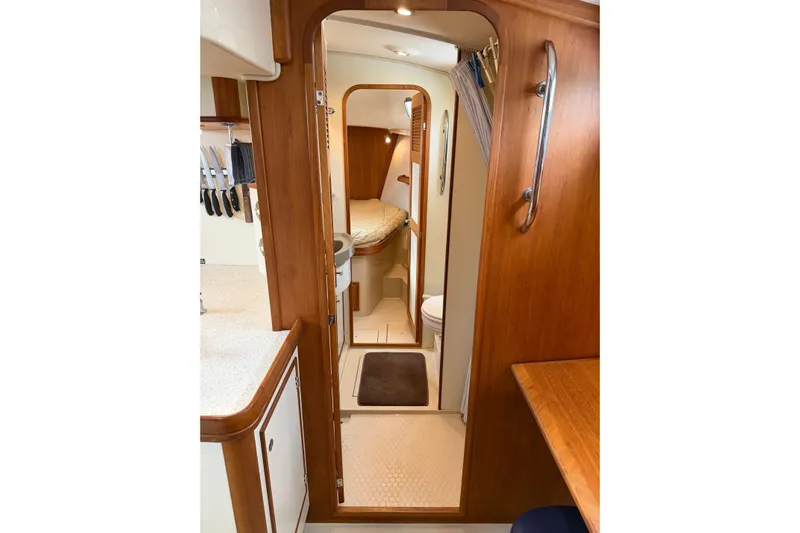  Yacht Photos Pics Interior of 2008 Island Packet SP Cruiser, featuring wood finishes and compact living space.