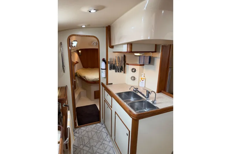  Yacht Photos Pics 2008 Island Packet SP Cruiser interior with kitchen and cozy sleeping area.