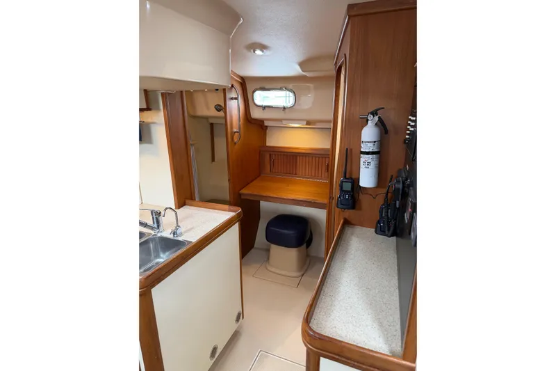  Yacht Photos Pics 2008 Island Packet SP Cruiser interior with kitchenette, seating, and navigation equipment.